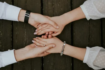 Two people holding hands across a table